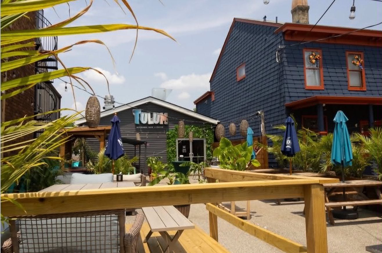 Tulum's outdoor patio strung with lights and greenery