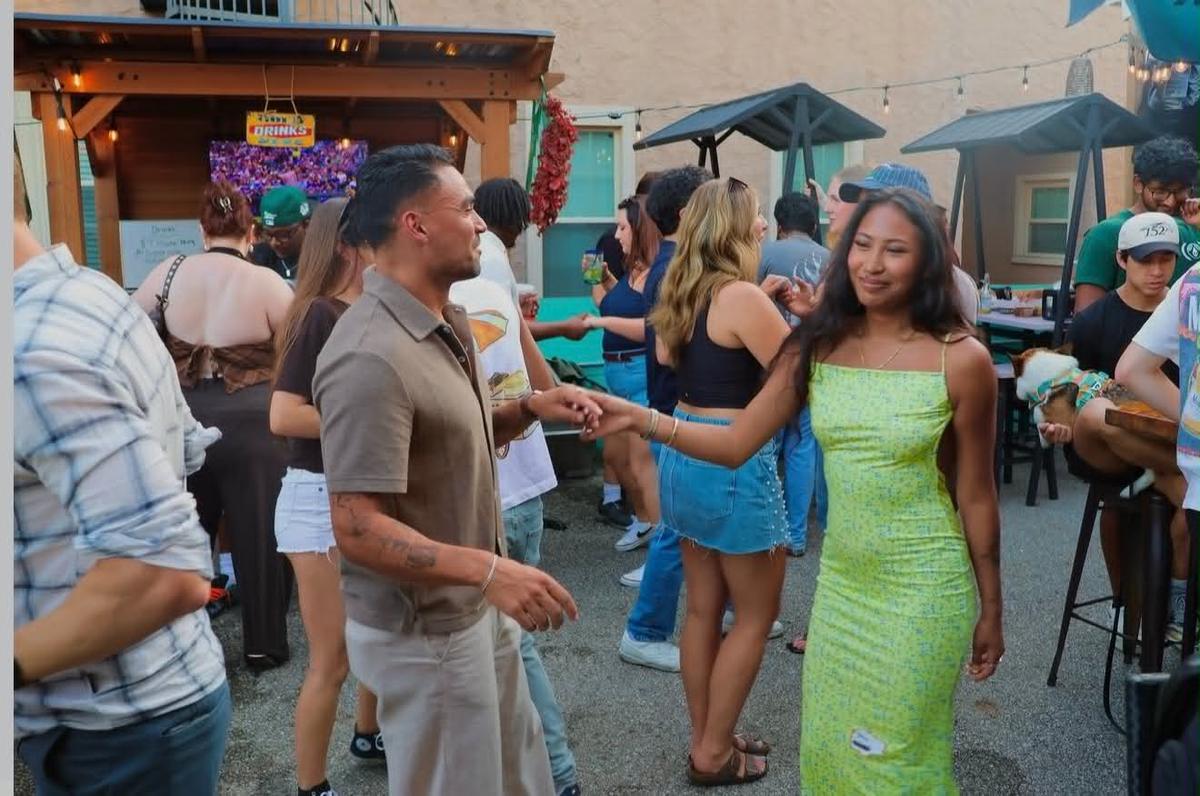 A couple dancing together on Tulum's patio