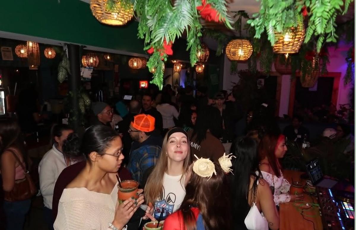 A lively crowd inside Tulum at night